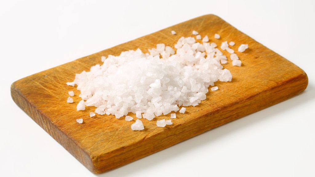 Salt spread onto wooden cutting board