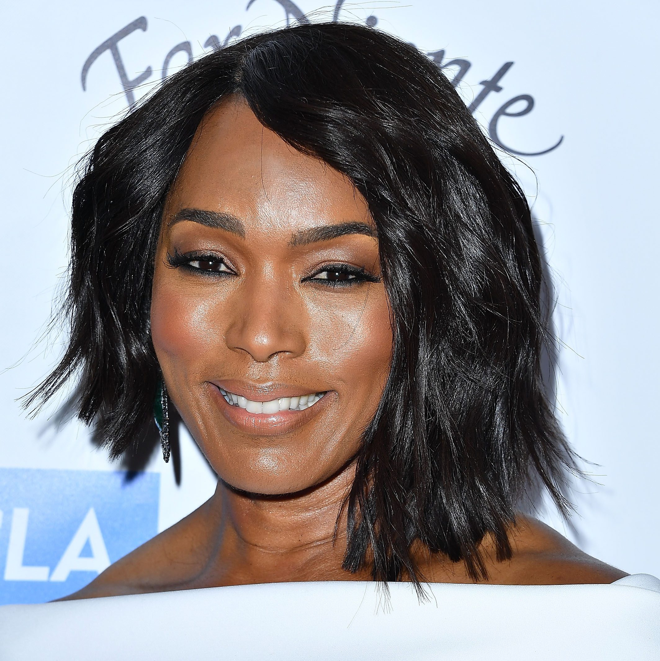 Angela Basset with a shoulder-length haircut that's shorter on one side and longer on the other side