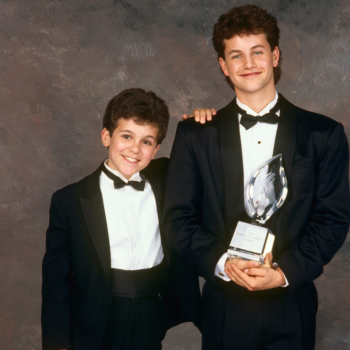 Fred Savage of 'The Wonder Years' and Kirk Cameron of 'Growing Pains' pose with the People's Choice Award, 1989 