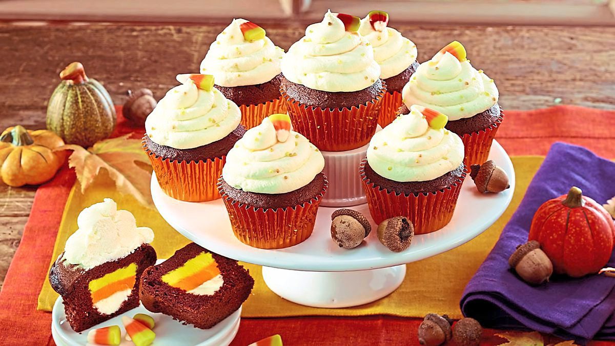 Surprise-Inside Candy Corn Cupcakes sit on a plate (halloween cupcakes)