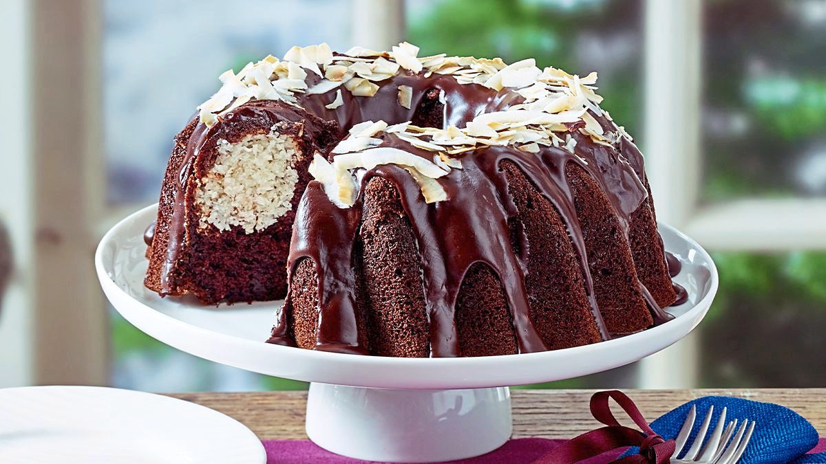 Double-Chocolate Coconut Bundt Cake sits on a white plate (coconut desserts)