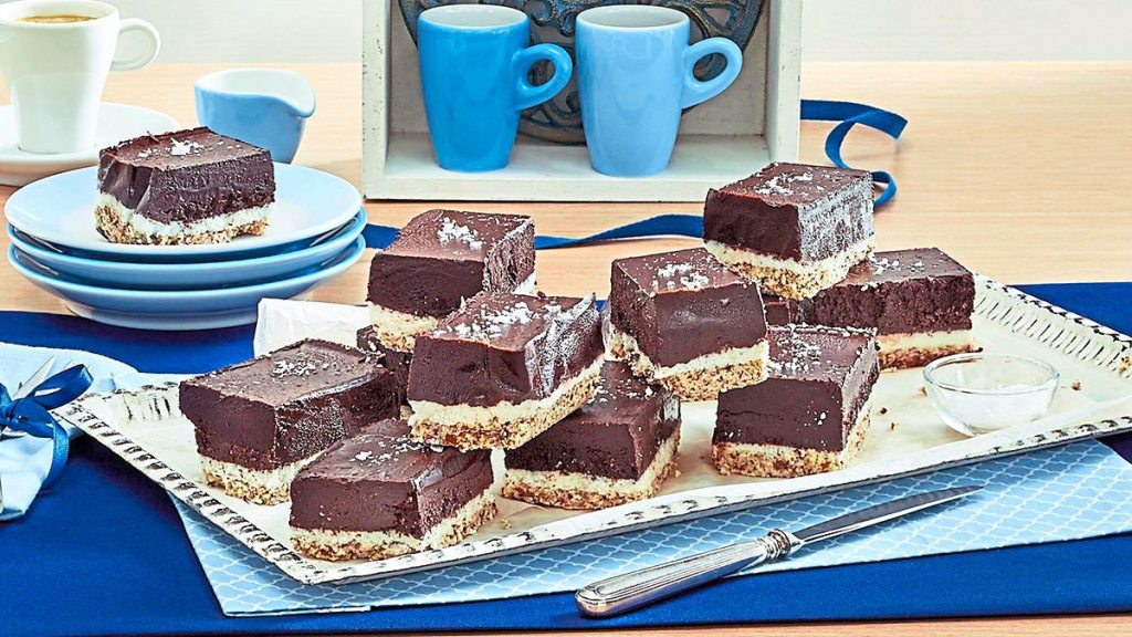 Fudgy Coconut Brownie Bites sits on a blue plate (coconut desserts)