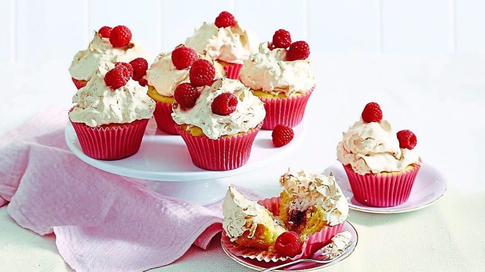 Raspberry-Coconut Cupcakes sits on a pink table (coconut desserts)