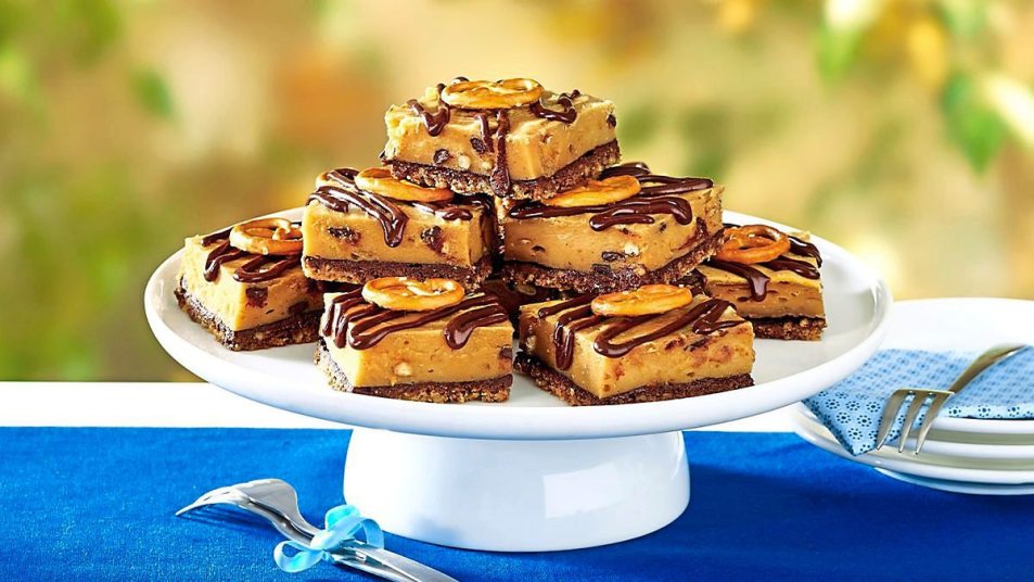 Peanut butter desserts: Peanut Butter-Pretzel Cheesecake Bars sits on a blue tablecloth