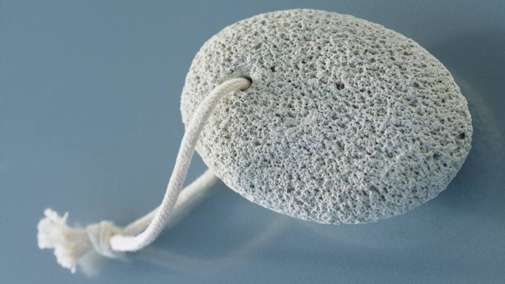 Pumice stone for cleaning on a blue background