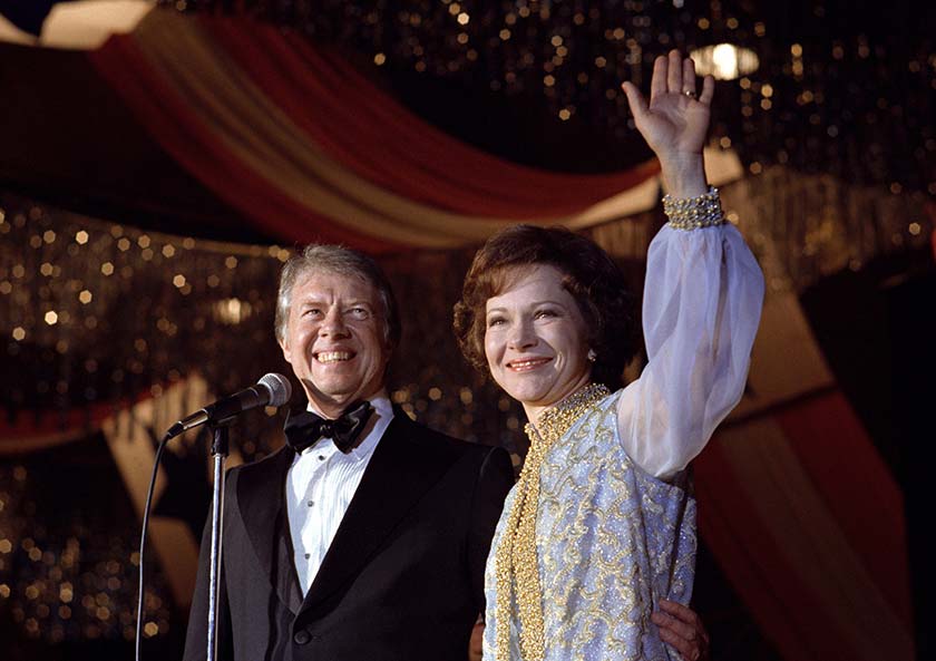 Jimmy Carter and First Lady Rosalynn Carter are shown here waving to inaugural ball guests on the evening of January 20, 1977