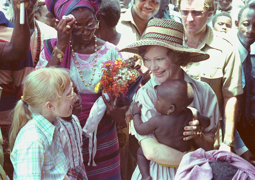 Rosalynn Carter holds a baby while Amy Carter looks on in Lagos, Nigeria, on April 2, 1978, during the first visit by a seated U.S. president to sub-Saharan