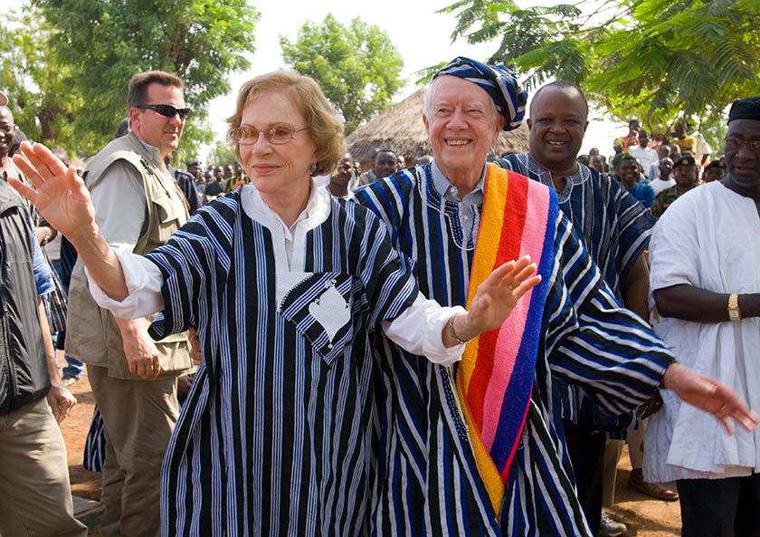 Jimmy and Rosalynn Carter wear traditional Ghanaian attire during a visit to Northern Ghana to view Carter Center health campaigns to eradicate Guinea worm disease and eliminate trachoma, on February 8, 2007
