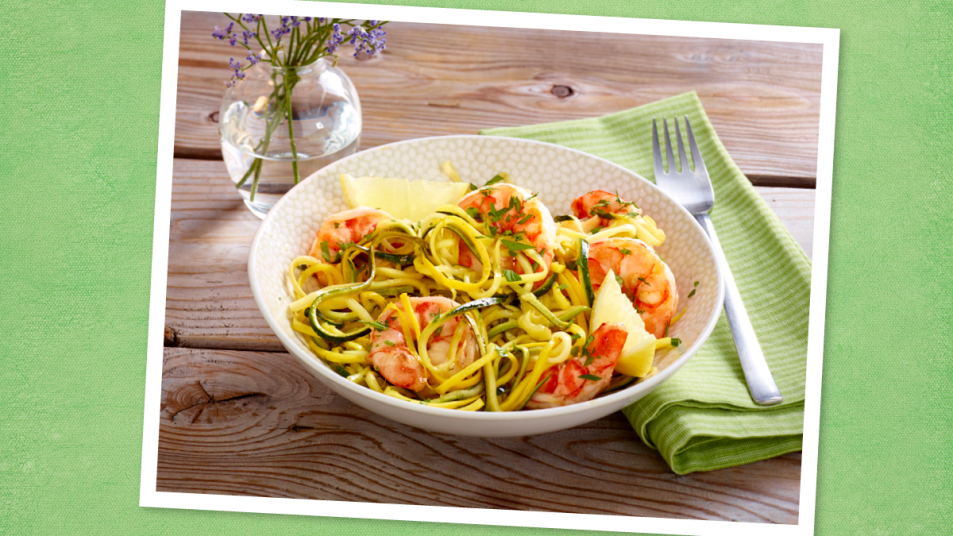 Shrimp Scampi with Zucchini Linguine sits on a green background (Monday night dinner ideas )