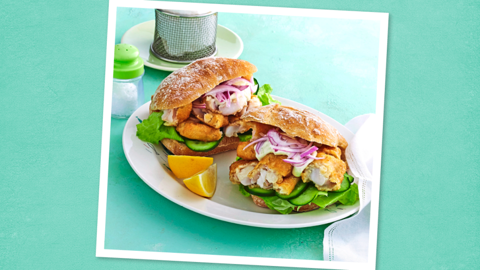 Crispy Fish Sandwiches sits on a teal background (Monday night dinner ideas )