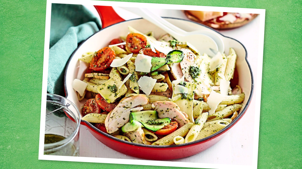 Pasta with Pesto and Chicken sits on a green background (Thin Sliced Chicken Breast Recipes)