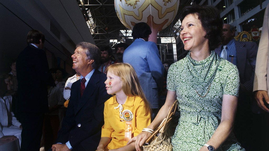 Jimmy Carter, Wife, and daughter Amy watch a puppet show at an Atlanta amusement complex in June 1976