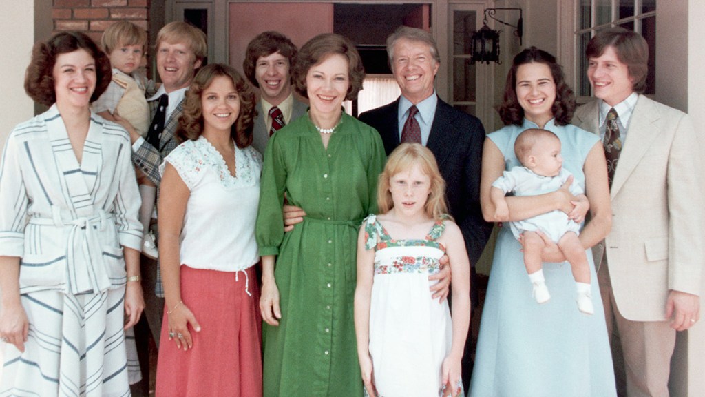 A portrait of President Jimmy Carter and his extended family. Left to right: Judy (Mrs. Jack Carter); Jason James Carter; Jack (John William Carter); Annette (Mrs. Jeff Carter); Jeff (Donnel Jeffrey Carter); First Lady Rosalynn Carter; daughter Amy Lynn Carter; President Carter; daughter-in law Caron Griffin Carter holding James Earl Carter IV; and son Chip (James Earl Carter III), 1977