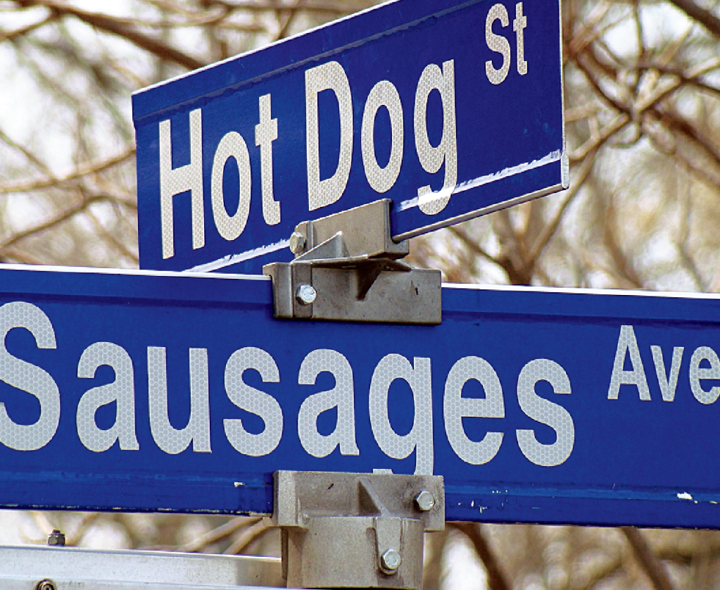 Funny signs: 2 intersecting street signs for Hot Dog St. and Sausages Ave.