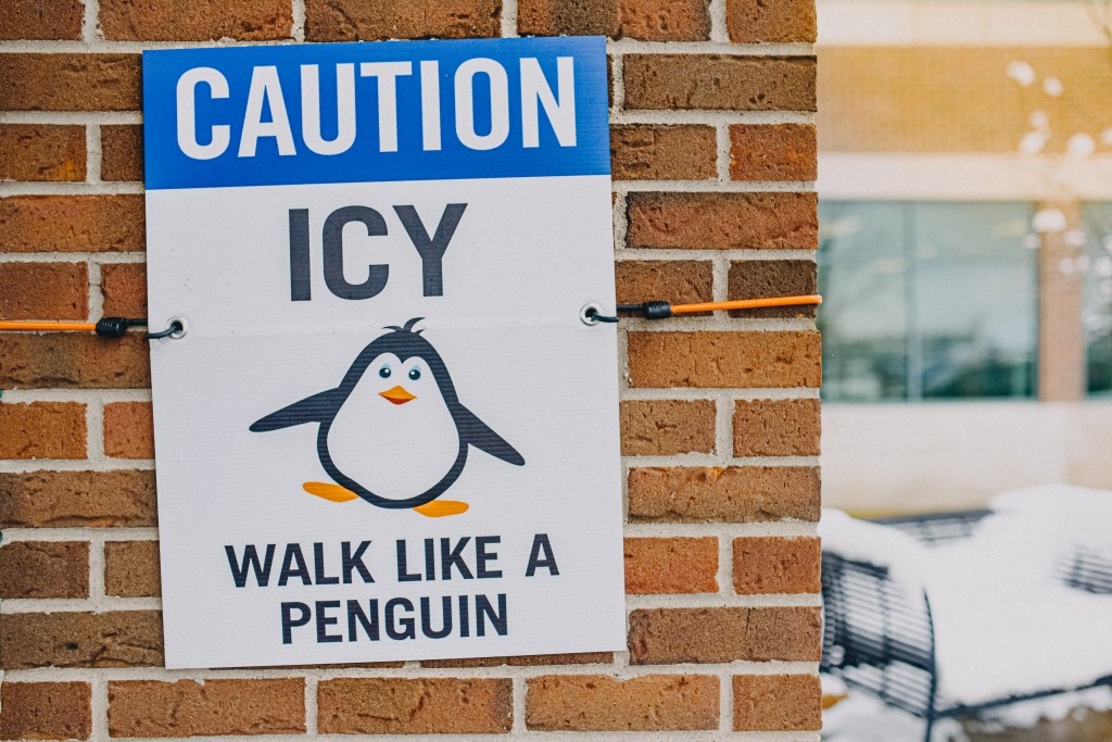 Funny Road Signs: Caution, Icy, Walk Like a Penguin with picture of cartoon penguin