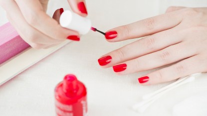 Woman painting her nails at-home gel nails
