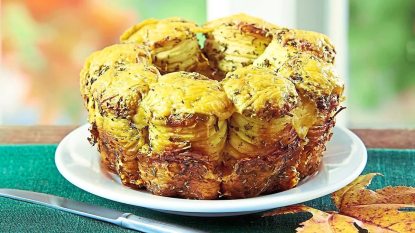 Savory Herb & Cheese Pull-Apart Bread sits on a white plate (Side dishes for meatloaf)