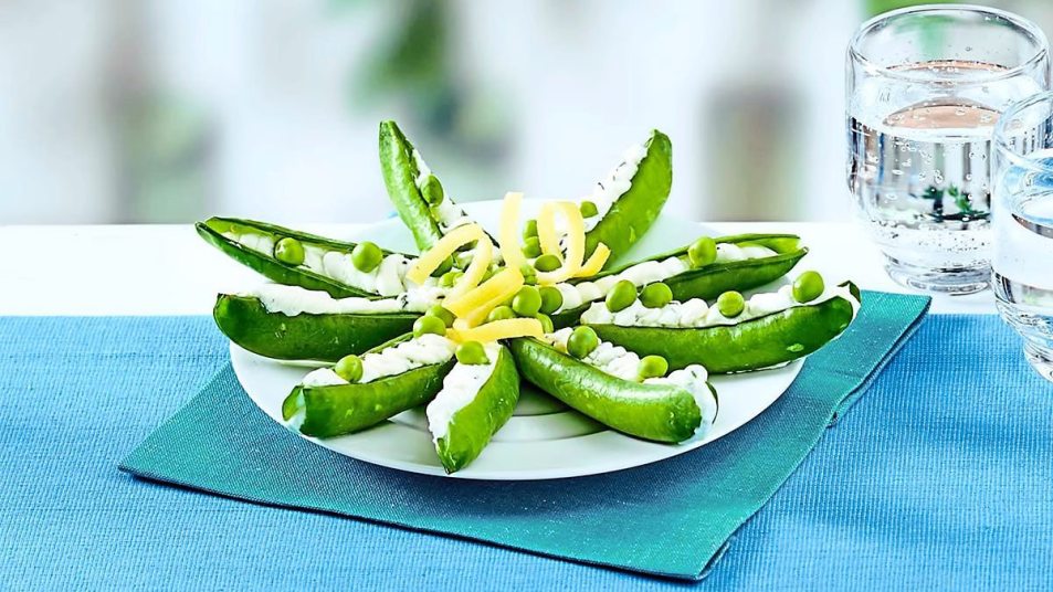 Cheese-Stuffed Snap Peas sits on a blue table (Side dishes for meatloaf)