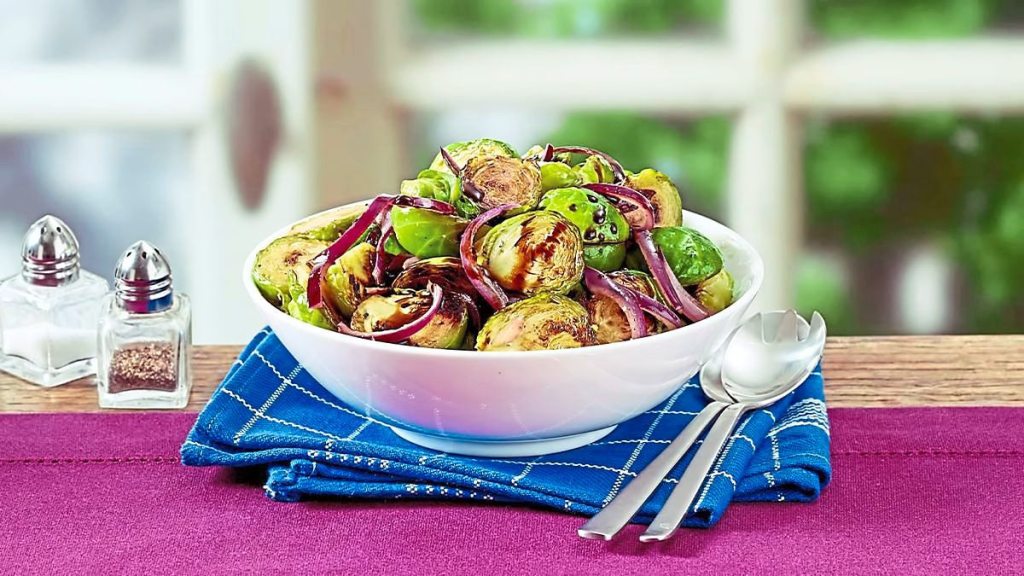 Crispy Balsamic Brussels Sprouts sits on a purple table (Side dishes for meatloaf)