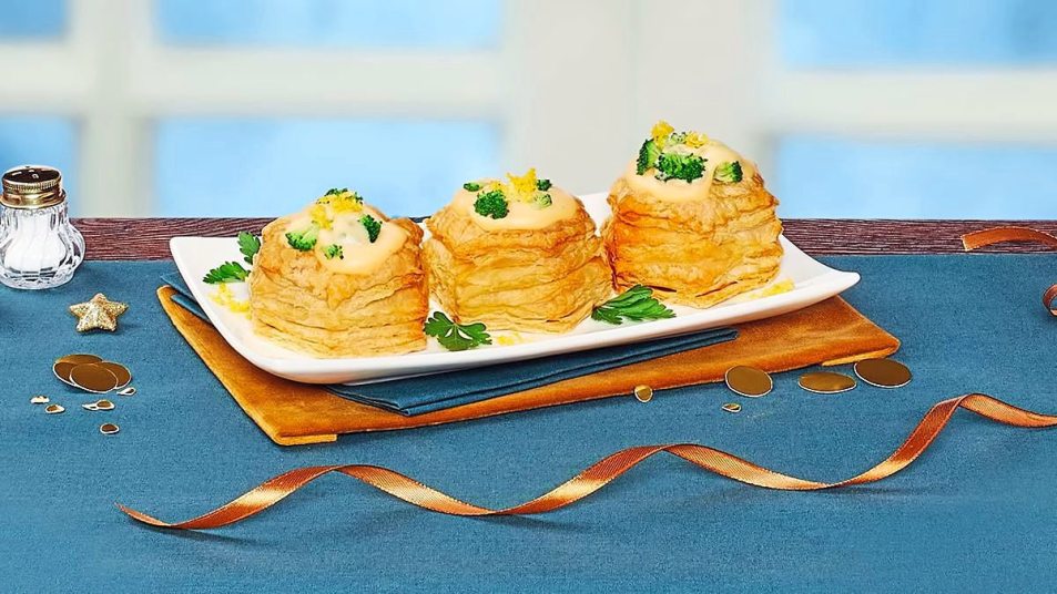 Cheesy Broccoli Puff Pastry Cups sits on a blue table (Side dishes for meatloaf)