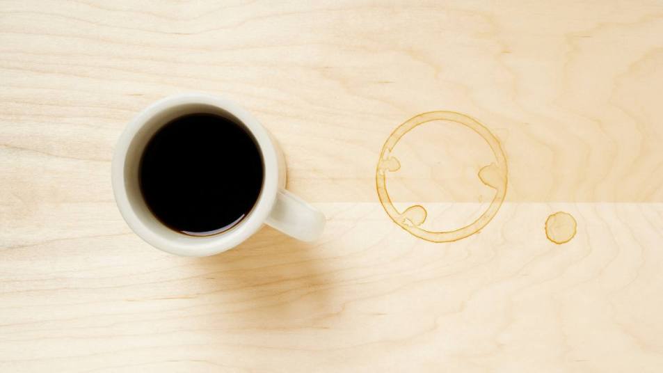 How to get stains out of wood: Cup of coffee and coffee ring on table