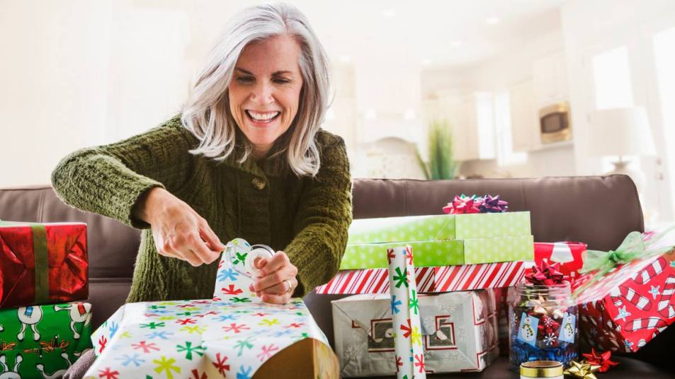 Last minute Christmas gifts: Caucasian woman wrapping Christmas gift