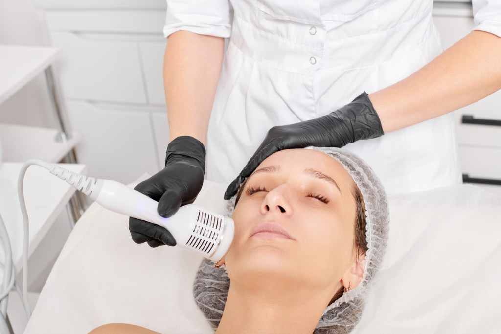 Woman getting a cryofacial done in spa