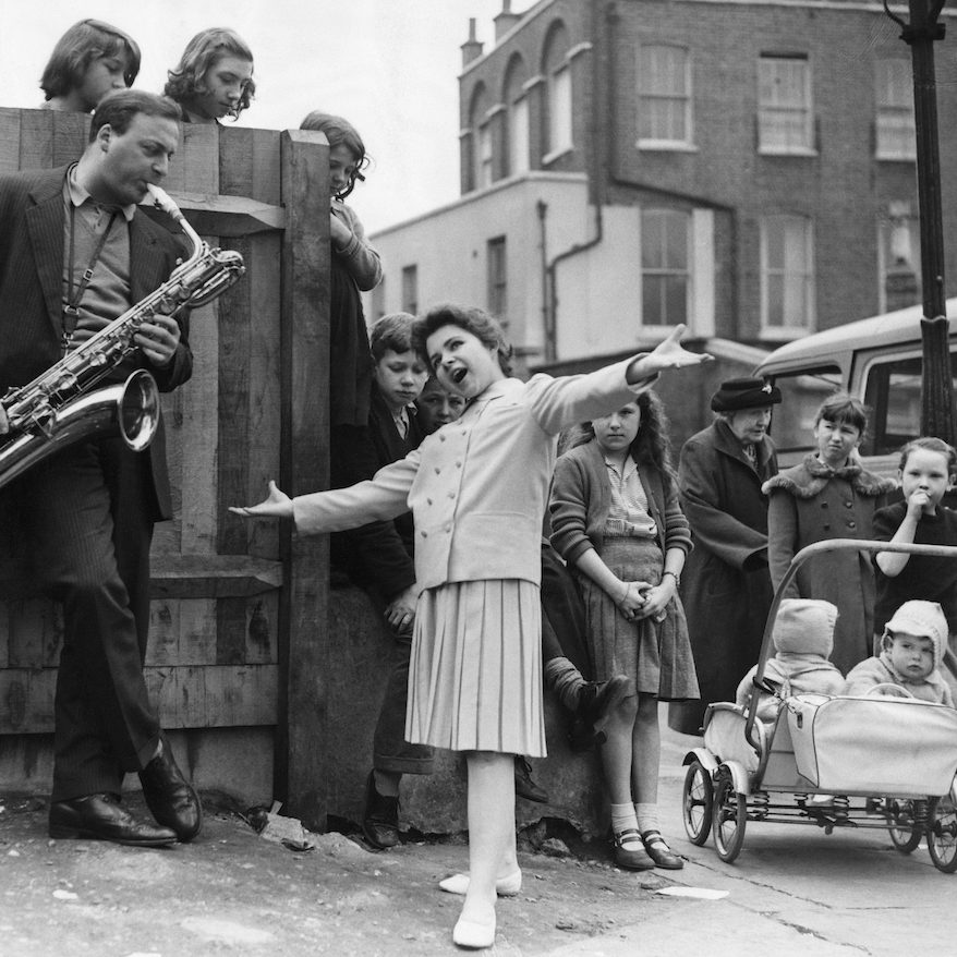 Brenda Lee performs on the street, 1959