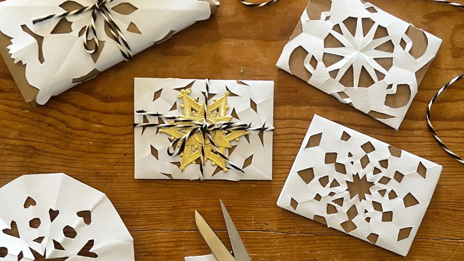 gift card wrapped in brown paper and DIY snowflakes: How to wrap a gift card