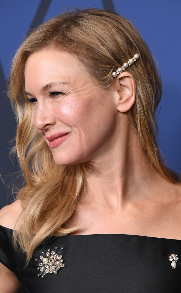 Renée Zellweger arrives at the Academy Of Motion Picture Arts And Sciences' 11th Annual Governors Awards wearing a black dress and rhinestone and pearl bobby pin in her hair that's styled down and to the side