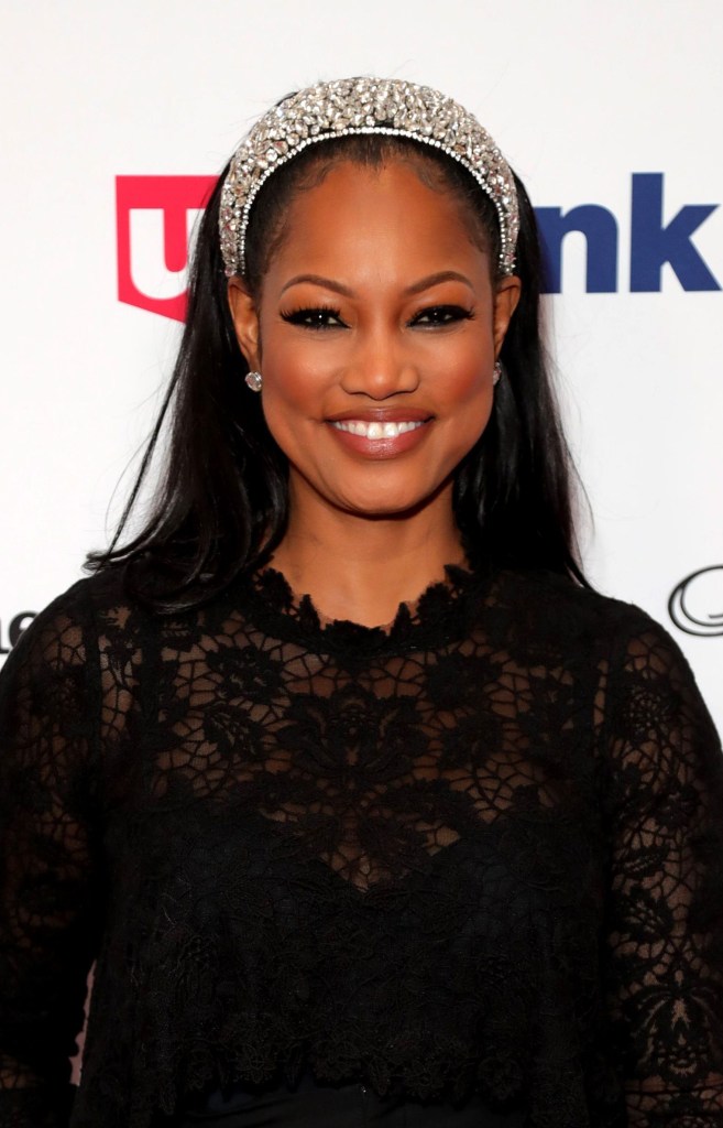 Garcelle Beauvais attends The Los Angeles Mission Legacy of Vision Gala at The Beverly Hilton Hotel on October 24, 2019 in Beverly Hills, California wearing a black dress and sparkly rhinestone-covered headband in her hair that's styled down