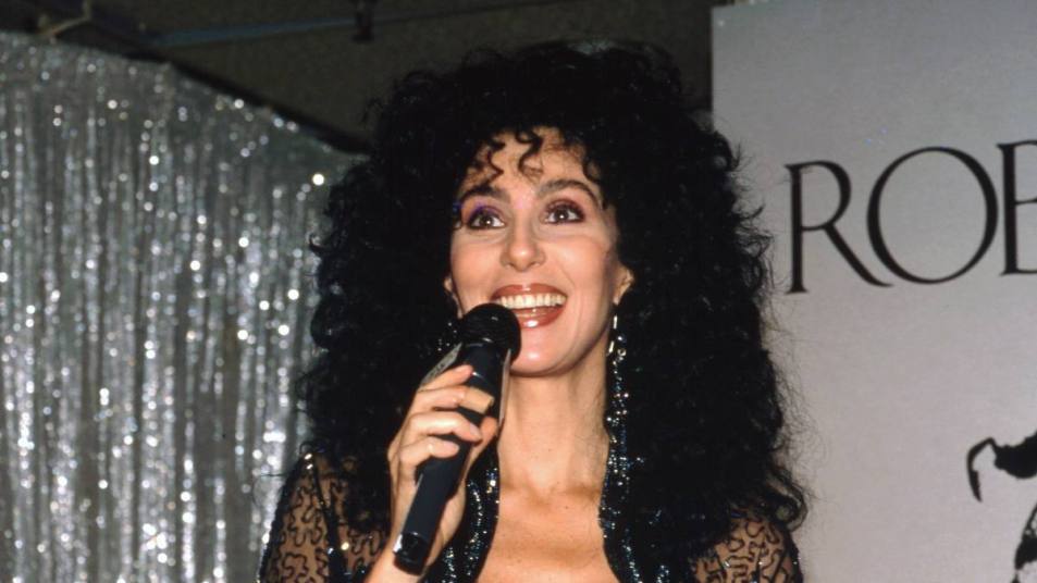 Young Cher holding a microphone; Cher movies