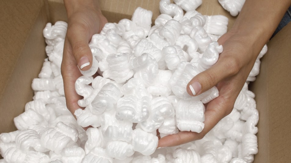 Woman's hands holding packing peanuts in box