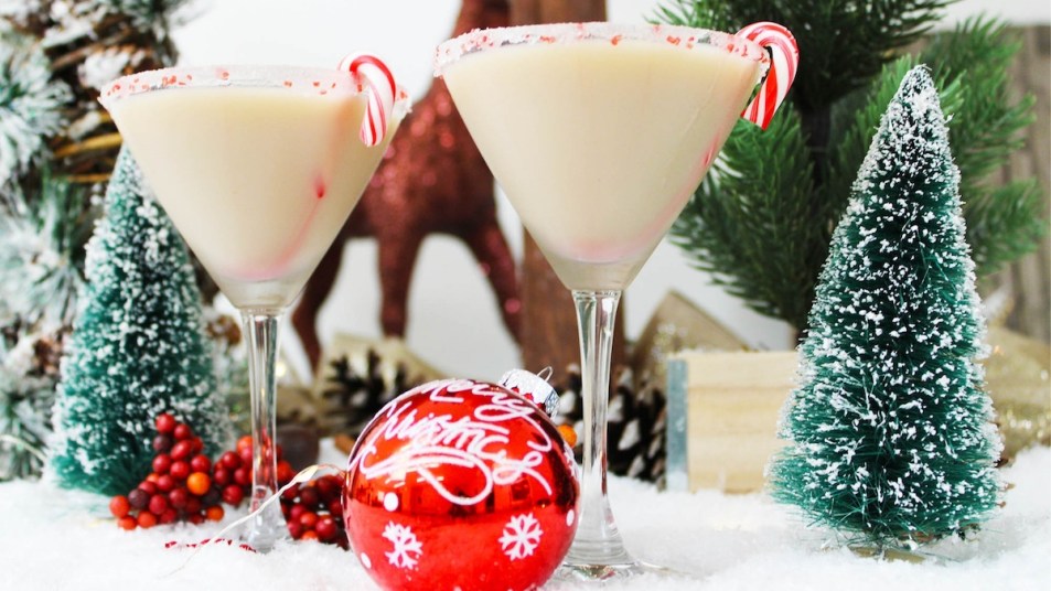 Two peppermint cocktails on table with Christmas decorations