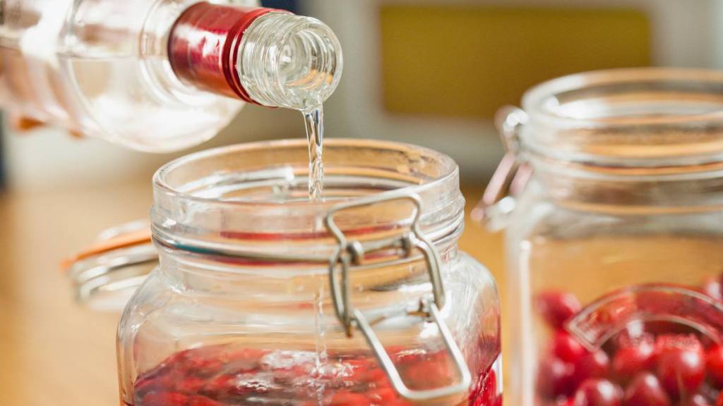 How to Clean Fruit: Adding Vodka to Cherries in Mason Jar