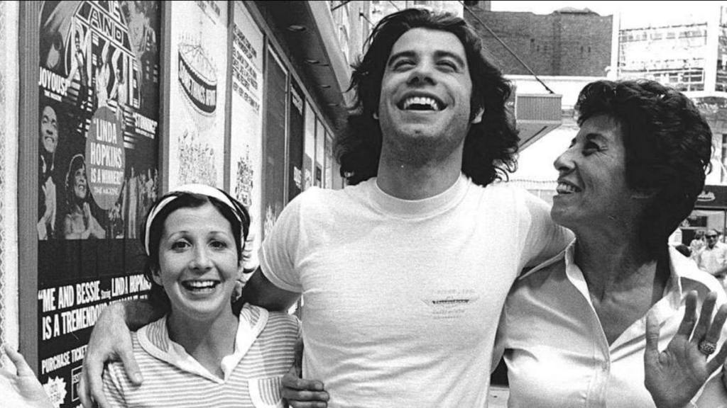 Man and two women laughing and smiling