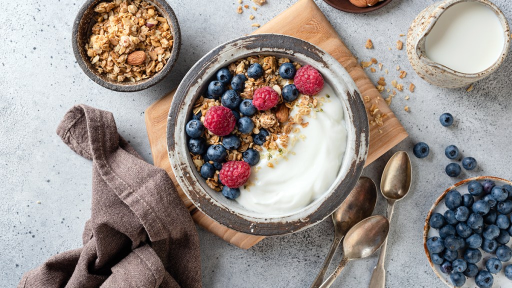 bowl of yogurt with berries and nuts; leaky gut symptoms