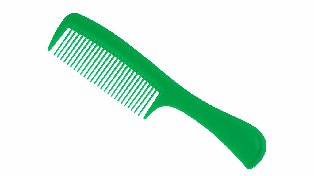 Green plastic fine-tooth comb on plain white background