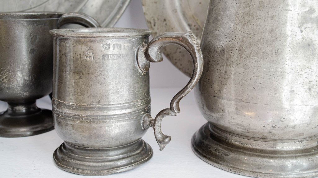 How to clean pewter: Pewter cups and a pitcher on a table