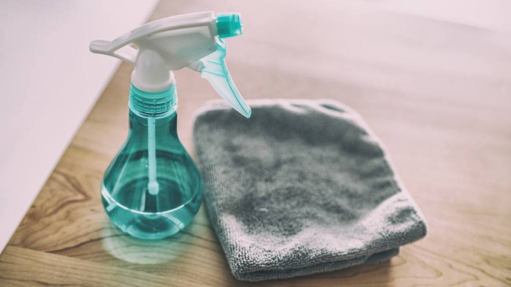 how to clean a flat iron: Surface cleaning home kitchen All purpose cleaner disinfectant spray bottle with towel to clean high touch surfaces from COVID-19 virus contagion.