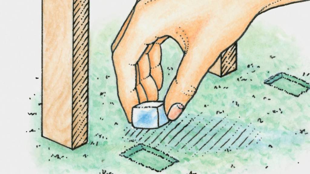 uses for ice cubes: Hand placing ice cube into dent in carpet caused by legs of table or chair (removing dent in carpet) - stock illustration