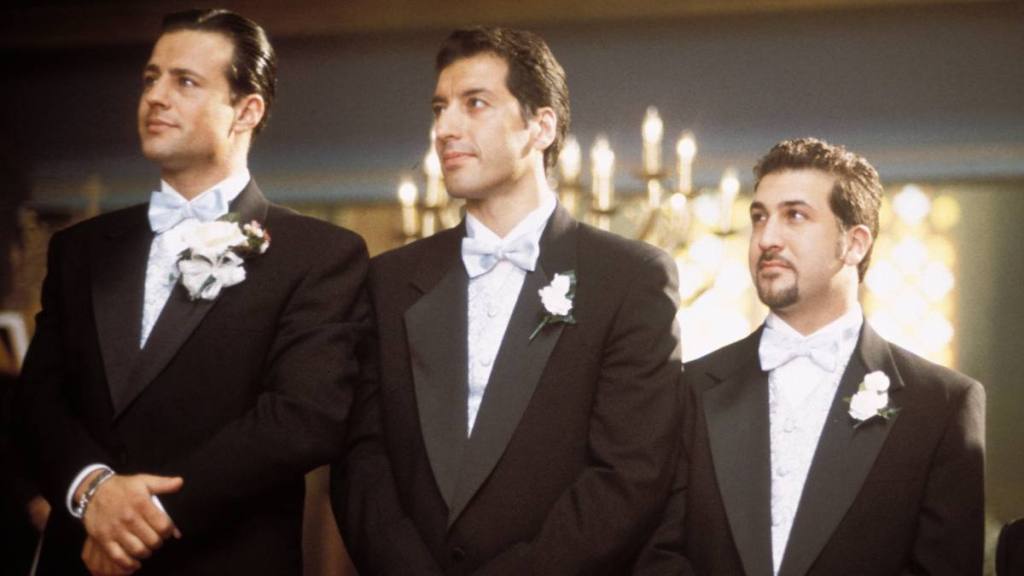 Three men standing at a wedding; nsync members