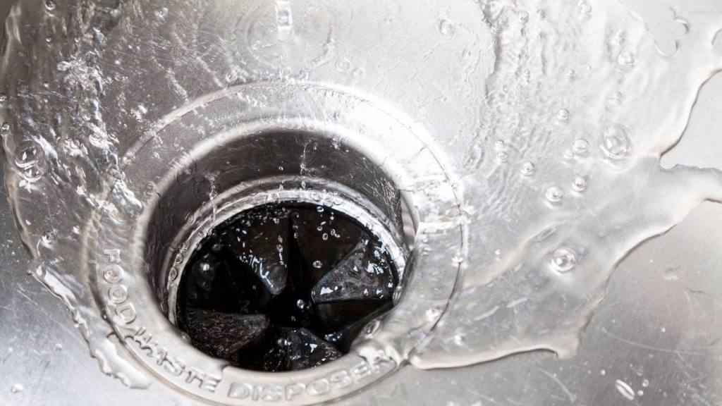 uses for ice cubes: Stainless steal kitchen sink with water drops
