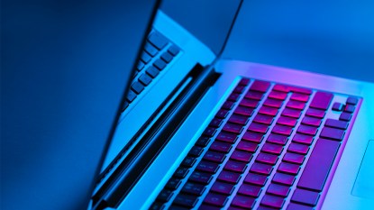 open laptop computer emitting blue light; blue light affects sleep