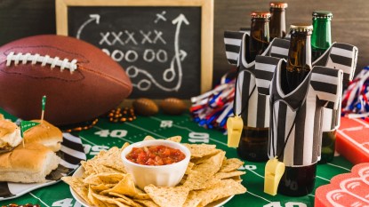 Table with Super Bowl party snacks and decor