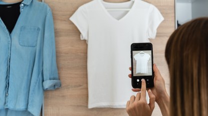 woman taking pictures of clothes to sell, making money from home