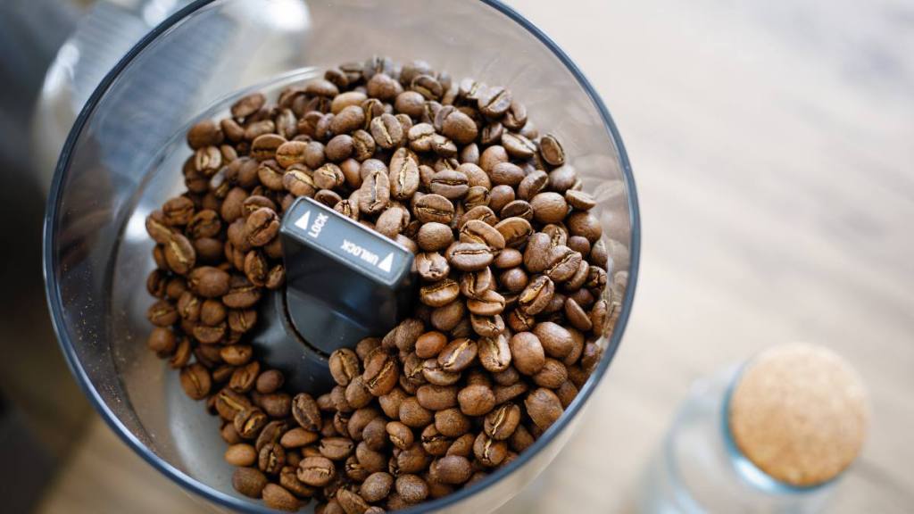 uses for sugar: Close up coffee beans in grinder