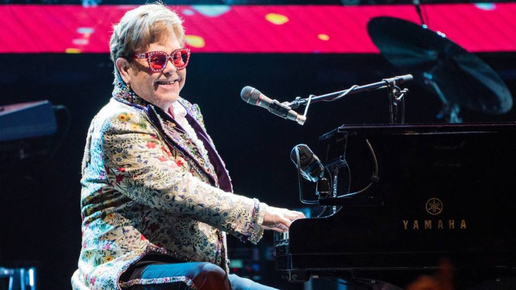 Elton John performs on the piano
