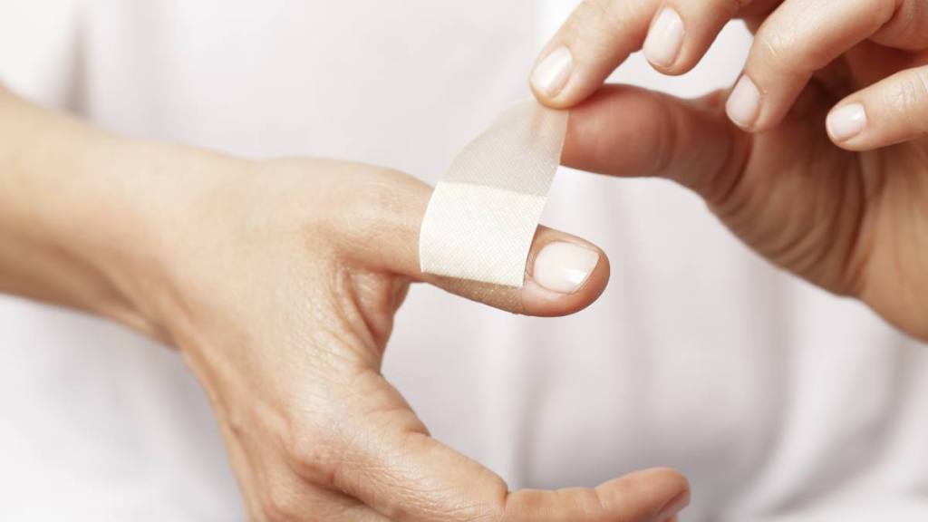 uses for sugar: Forefinger of a woman hand with a band aid