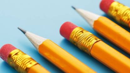 uses for pencil erasers: Orange pencils with an eraser on a blue background. Free space